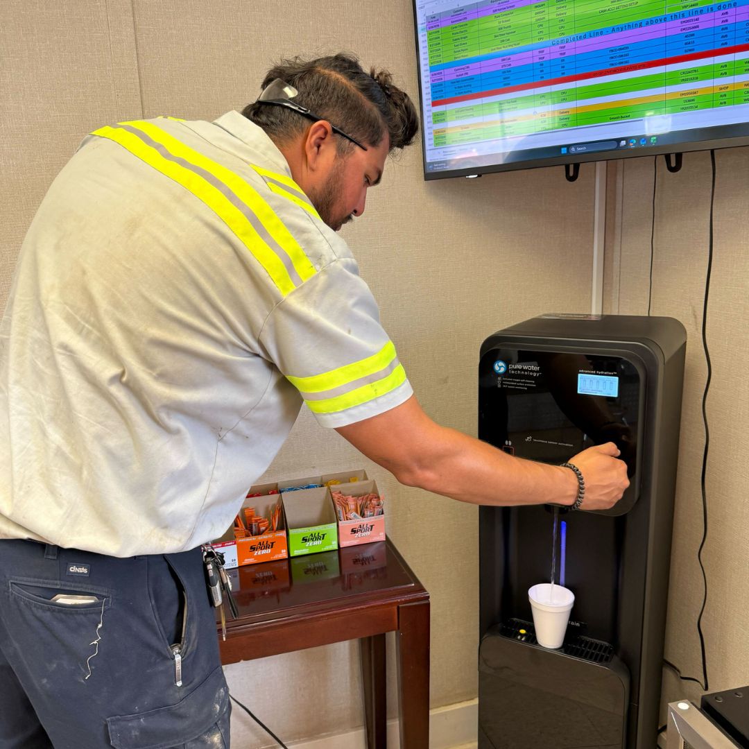 Worker staying Hydrated with Optimum's Clearly Pure Water