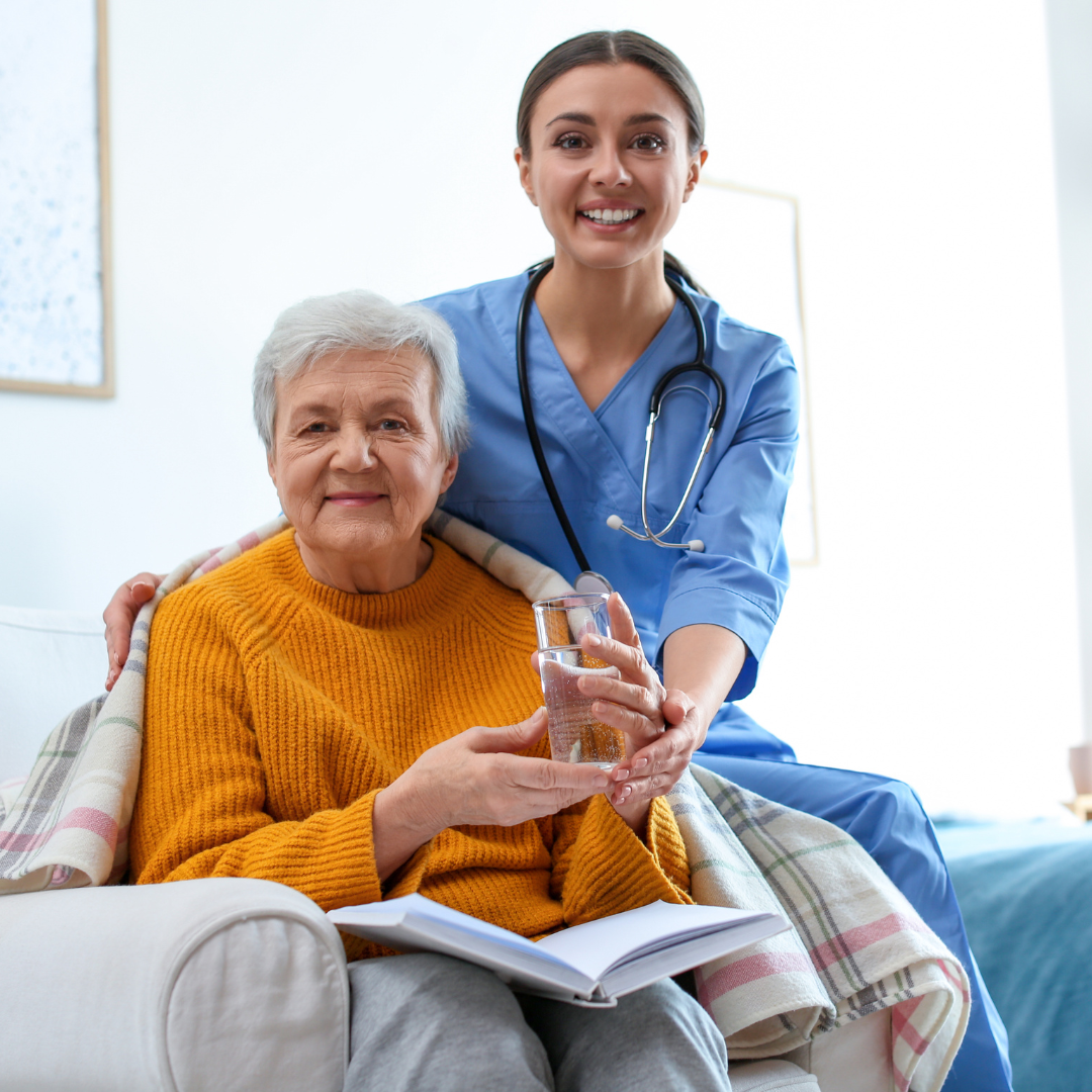 An elderly woman in a Senior Living Community drinking a glass of Optimum Purified Water from a Water cooler.